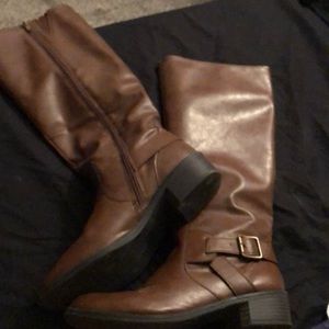 Calf high brown leather boots.